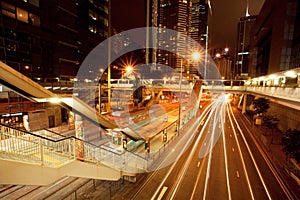 Dark streets with hotels, skyscrapers and motion lines near city tram stop