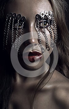 Dark studio beauty portrait with chains