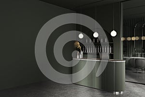 Dark stylish barbershop with reception desk, laptop and mock up wall