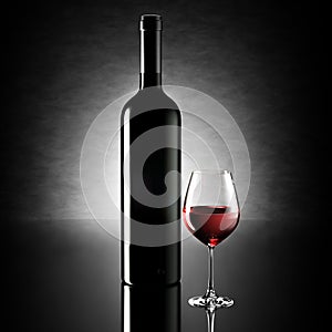 Dark tall wine bottle mockup next to filled glass on reflective surface, soft light highlighting contours, creating luxury
