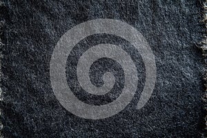 Dark textured stone surface with subtle light play. Neural network AI generated