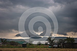 Dark threatening storm clouds over a hill in the countryside