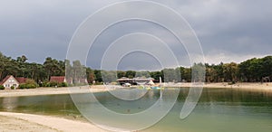 Dark thunderstorm clouds above a lake of recreation park in `t Loo, Netherlands