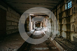 Dark tunnel in old abandoned brick factory. Abandoned industrial corridor