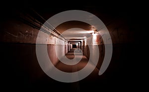 Dark underpass with dim lights and graffitis