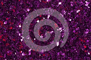 Dark violet glitter confetti on shiny background. Purple glitter texture. photo