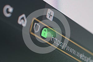 Dark web browser close-up on LCD screen with shallow focus on https padlock