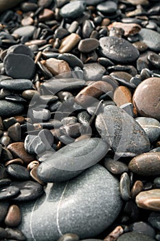 Dark wet pebbles on the ocean shore