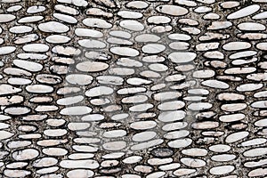 Dark wet pebbles texture on concrete floor background. Gravel texture background