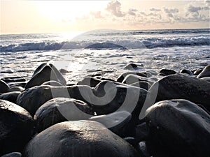 Dark wet and shiny rocks on the sea side in Madeira