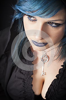 Dark woman with blue hair and lipstick. Key pendant. Dark girl