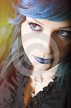 Dark woman with blue hair and lipstick. Key pendant. Dark girl