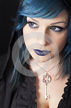 Dark woman with blue hair and lipstick. Key pendant. Dark girl