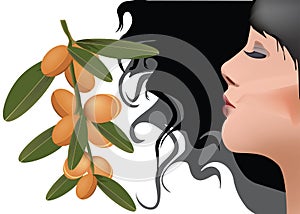 Profile of dark woman with fruits of argan photo