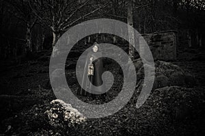 Dark woman walking in the gothic forest