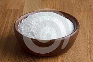 Dark wood bowl of dessicated coconut photo