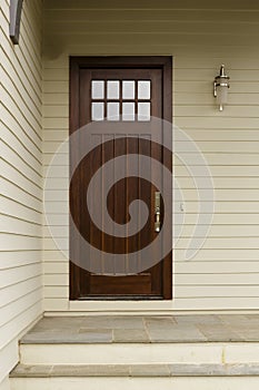 A dark wood slim front door