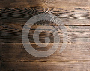 Dark wooden background with knots. Wood planks with natural pattern texture. Empty brown wooden background