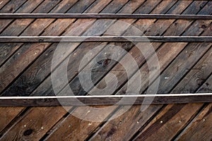 Dark wooden background from wood stains treated with stain with a diagonal pattern