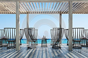 Dark wooden chairs and tables, seaside