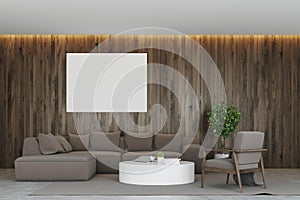 Dark wooden living room, gray sofa, poster