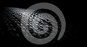 Dark woven texture illuminated by dramatic light