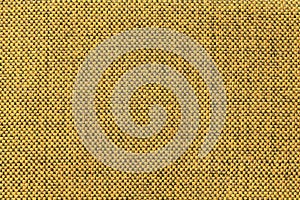 Dark yellow textile background with chess pattern, closeup. Structure of the fabric macro.