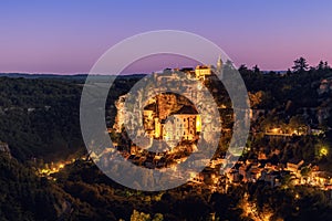 Darkness covered up the sky and bright illumination comes from every little window of medieval Rocamadour village. Lot