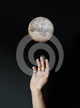 Darkness effected spinning globe and hand reaching