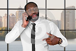 Darkskinned man on the phone.