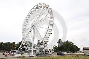 DARLOWO, POLAND - AUGUST 22, 2022: Large white observation wheel in amusement park