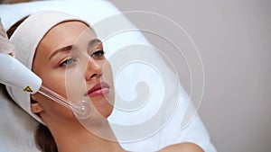 Darsonval cosmetology apparatus. Face clean procedure. Salon treatment
