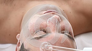 Darsonvalization. Man having darsonval therapy. Facial skin care in beauty saloon. electric darsonval massage procedure