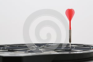 Dart arrow aimed at the dart game-board photo