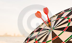 Dart arrow hit center on bullseye dartboard is target