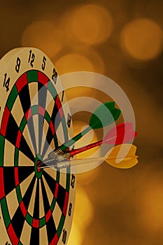 Dart arrow hitting in bullseye on dartboard