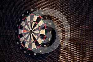 Dart arrow hitting in the target center of dartboard. Darts board.Success hitting target aim goal achievement concept background