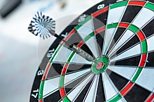 Dart arrow hitting in the target center of dartboard using as background Target business, achieve and victory,success concept