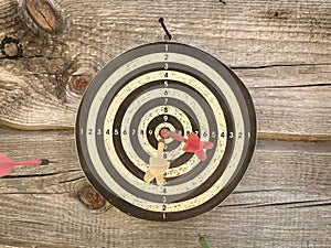 Dart board with color arrows hitting target, closeup