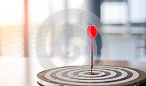 The dart board has an arrow thrown into the center of the shooting target for business targeting