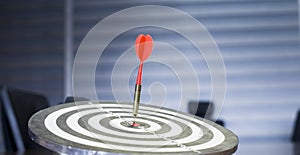 The dart board has an arrow thrown into the center of the shooting target for business targeting