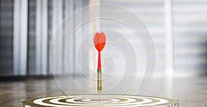 The dart board has an arrow thrown into the center of the shooting target for business targeting