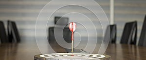 The dart board has an arrow thrown into the center of the shooting target for business targeting