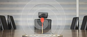The dart board has an arrow thrown into the center of the shooting target for business targeting