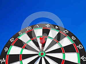 Dart Board Isolated on blue sky background, Setting challenging business goals And ready to achieve the goal concept