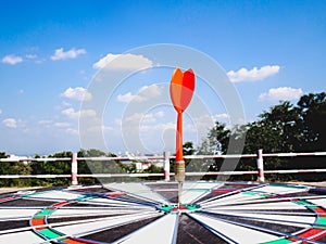 Dart Board Isolated on blue sky and city view background, Setting challenging business goals And ready to achieve the goal concept