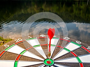 Dart Board Isolated on water view background, Setting challenging business goals And ready to achieve the goal concept