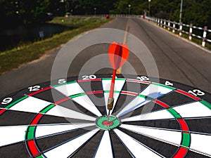 Dart Board  on Road view background, Setting challenging business goals And ready to achieve the goal concept