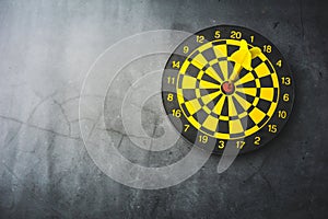 Dart board with yellow arrows hitting target, closeup
