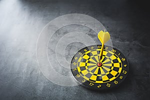 Dart board with yellow arrows hitting target, closeup